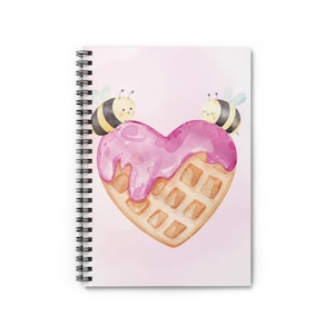 May include: A pink and white heart-shaped waffle with pink icing and two cartoon bees on top. The waffle is on a pink background.