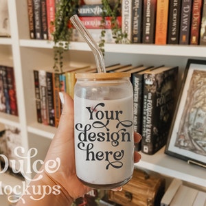 May include: A clear glass tumbler with a bamboo lid and a glass straw. The tumbler is filled with a light pink liquid and has the text "Your design here" printed on the side.