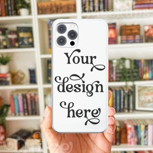 May include: White iPhone case with a black camera lens and the text "Your design here" printed on the back.