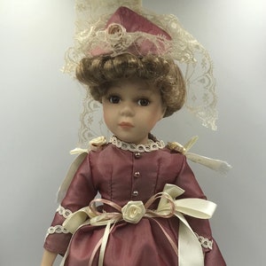 Collector&#39;s Choice Porcelain Bisque Doll on stand with Certificate of Authenticity