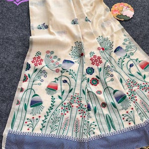 Floral linen saree pastel color Indian saree
Designer saree with printed pallu tassels
Soft cotton linen saree elegant floral design
Traditional Indian saree modern pastel style
Lightweight festive saree with blouse piece