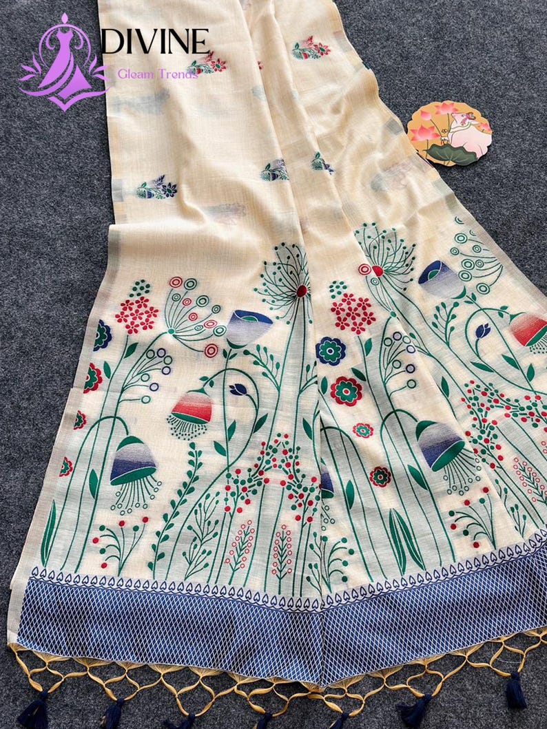 Floral linen saree pastel color Indian saree
Designer saree with printed pallu tassels
Soft cotton linen saree elegant floral design
Traditional Indian saree modern pastel style
Lightweight festive saree with blouse piece