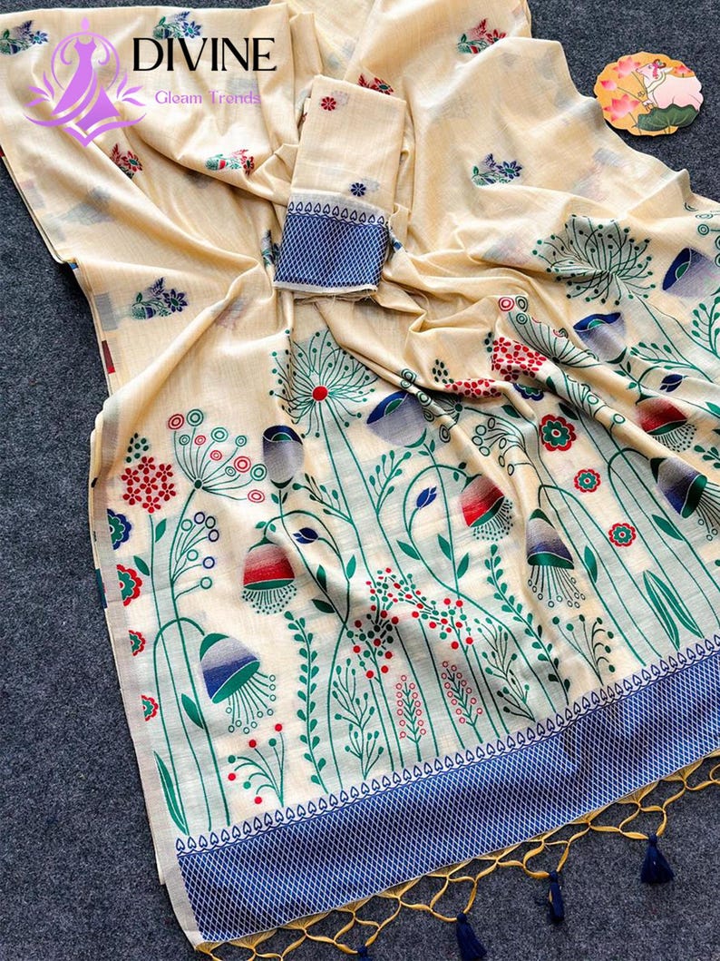 Floral linen saree pastel color Indian saree
Designer saree with printed pallu tassels
Soft cotton linen saree elegant floral design
Traditional Indian saree modern pastel style
Lightweight festive saree with blouse piece