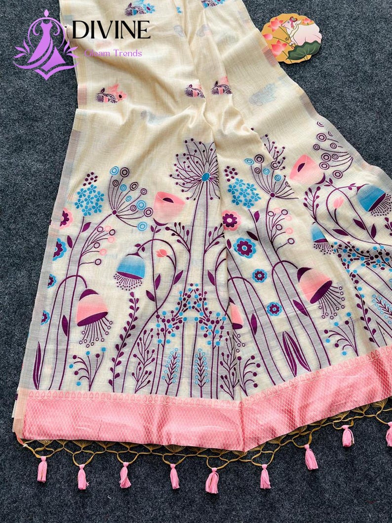 Floral linen saree pastel color Indian saree
Designer saree with printed pallu tassels
Soft cotton linen saree elegant floral design
Traditional Indian saree modern pastel style
Lightweight festive saree with blouse piece