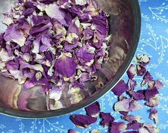 May include: A silver bowl filled with dried rose petals. The petals are a mix of light pink and purple.