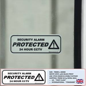 May include: White vinyl security alarm sticker with black print. The sticker reads "Security Alarm Protected 24 Hour CCTV" with a black exclamation point inside a triangle. The sticker is 70mm by 26mm.
