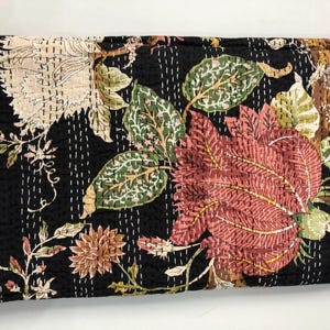 May include: Black kantha quilt with a floral pattern in shades of pink, green, and white. The quilt is hand-stitched and has a traditional Indian design.