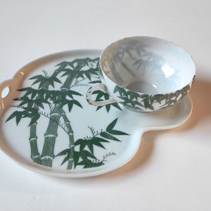 Set of four delicate cups and snack plates
