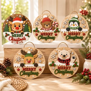 May include: Five circular wooden Christmas signs with hanging ropes. Each sign features a different character: a reindeer, a bear with a candy cane, a penguin, another reindeer, and a polar bear. All signs include the text Merry Christmas.