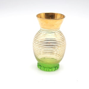 small, fine vase made of glass with gold decoration, shimmering green in the base