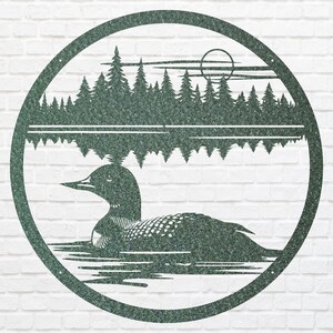 May include: A circular metal wall art piece featuring a loon swimming on a lake, with a forest and sun in the background. The artwork is a dark green color and is set against a white brick wall.