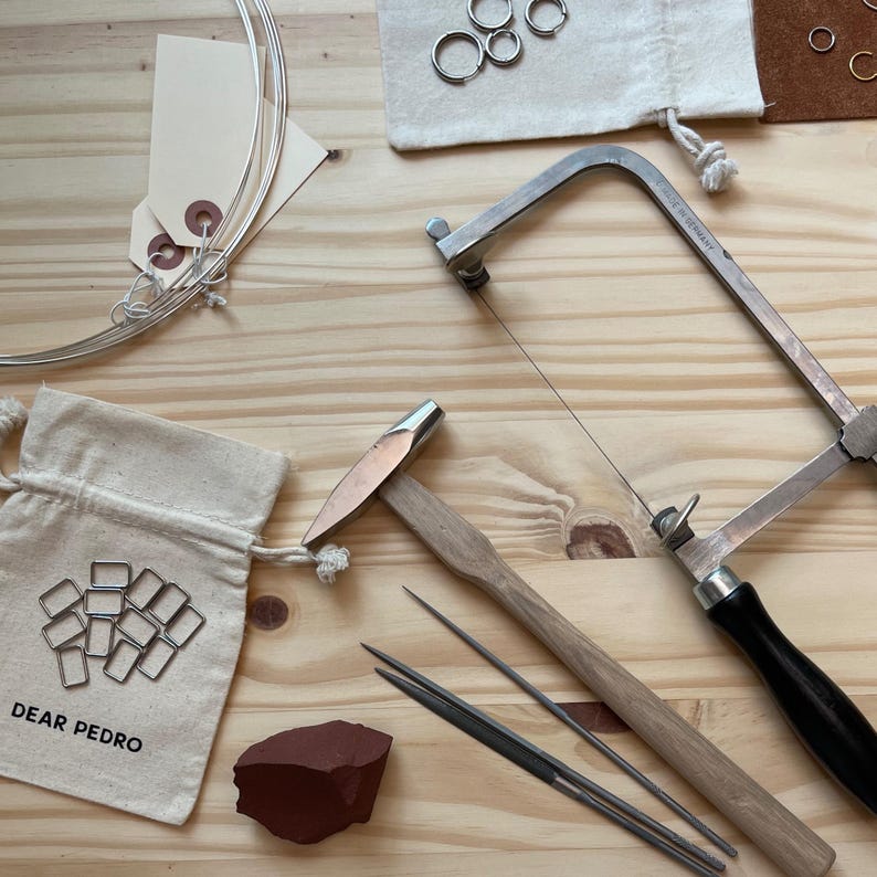 Jewelry making tools and materials for Dear Pedro hoop earrings, minimalist stainless steel jewelry craftsmanship and packaging.
