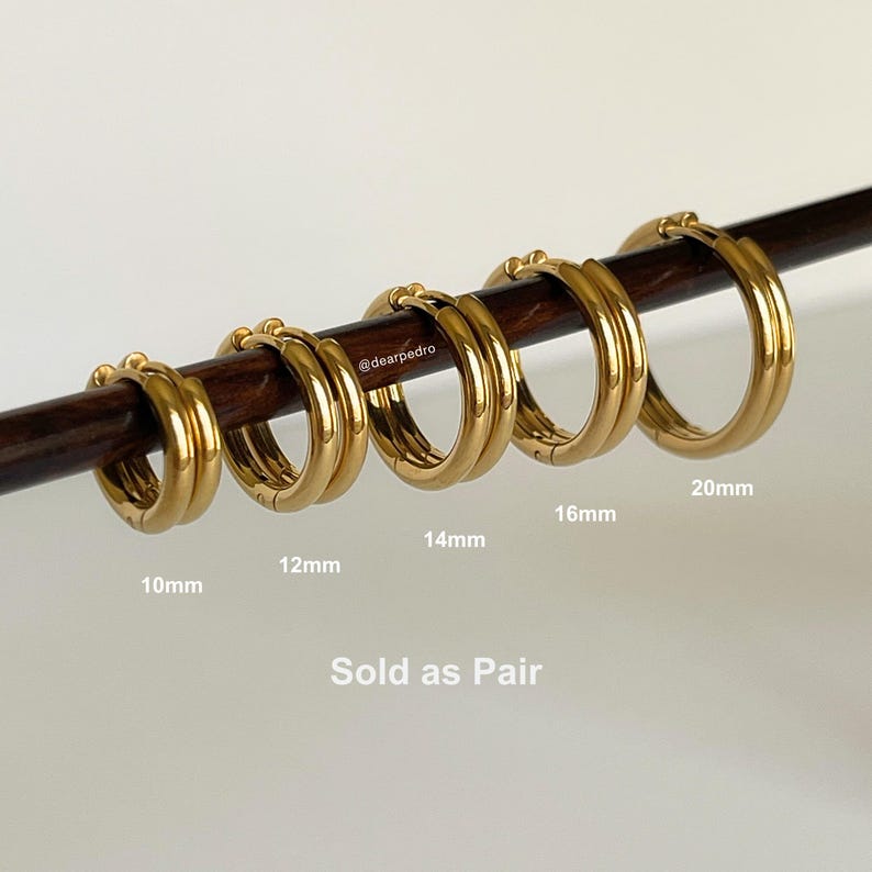 Gold 316L stainless steel hinged hoop earrings displayed on rod with sizes 10mm, 12mm, 14mm, 16mm, and 20mm, sold as a pair, minimalist stackable hoops.