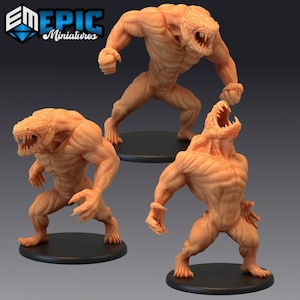 May include: Three 3D printed miniatures of a humanoid creature with reptilian features. The creature is standing on a black base and has a light brown colour.