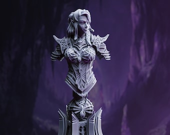 May include: A gray bust sculpture of an elf woman wearing intricate armor with spider-like details. The bust is mounted on a pedestal with a similar design.