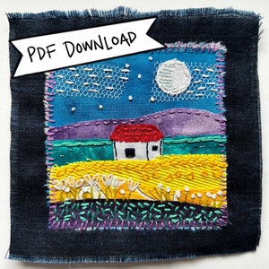 May include: A colorful embroidered artwork depicting a small white house with a red roof, set against a blue sky with a white moon and stars. The house is situated in a field of yellow flowers with white blossoms. The artwork is framed with a dark blue fabric border.