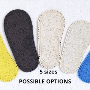 May include: Five different coloured leather soles for baby shoes. The soles feature a sun, moon, and owl design. The text "5 sizes" and "POSSIBLE OPTIONS" is printed below the soles.