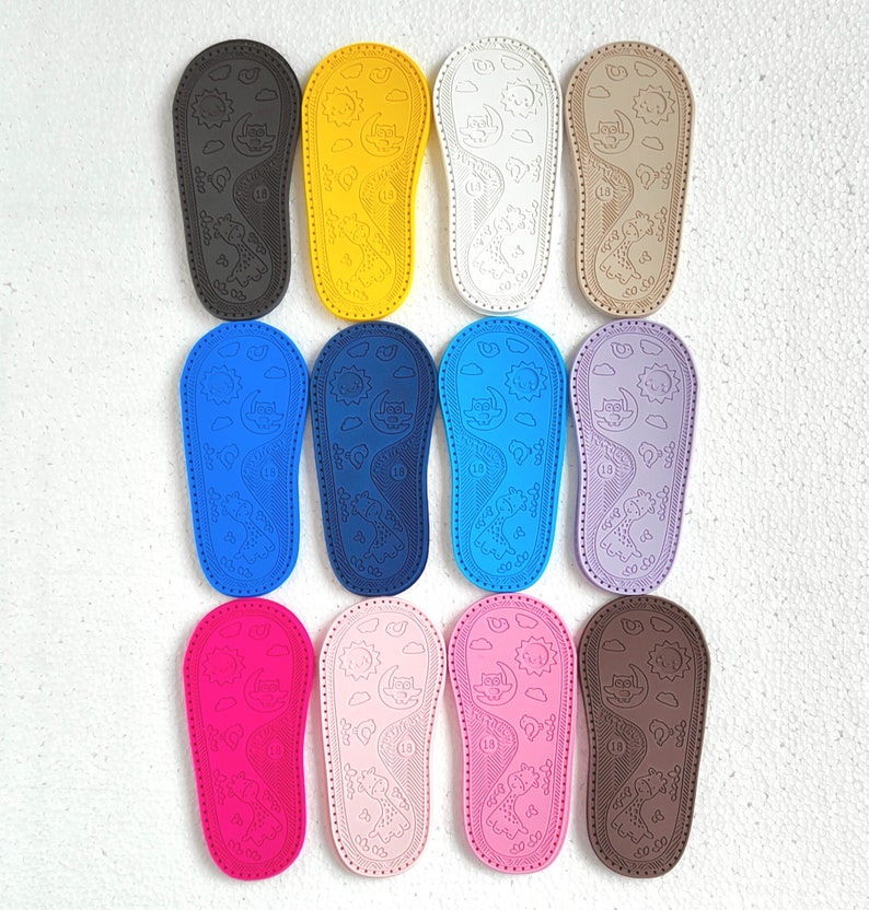 May include: Ten pairs of colorful baby shoes with a sun and moon design. The shoes are made of a soft, flexible material and are perfect for little feet.