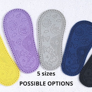 May include: Five pairs of colourful baby shoe soles featuring a giraffe and moon design. The soles are made from a soft, flexible material and are available in five sizes.