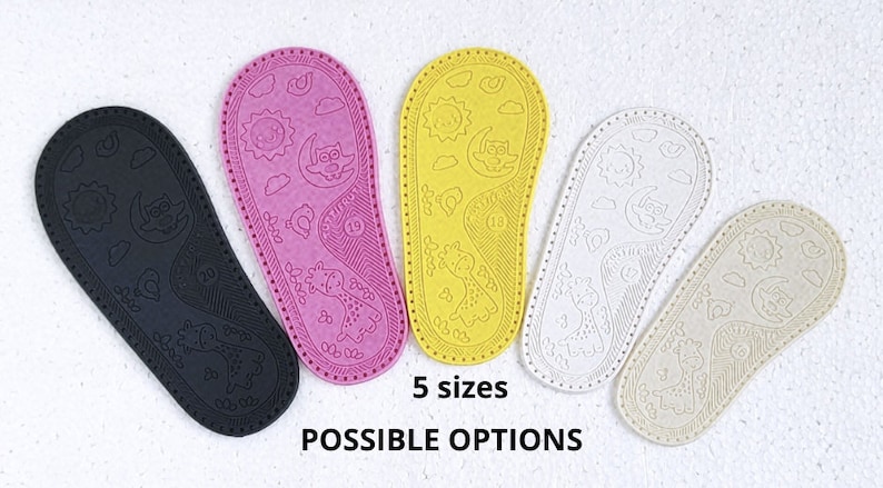 May include: Five pairs of colourful shoe soles with a whimsical design featuring a sun, moon, clouds, and an owl. The soles are made of a textured material and are available in black, pink, yellow, white, and beige.