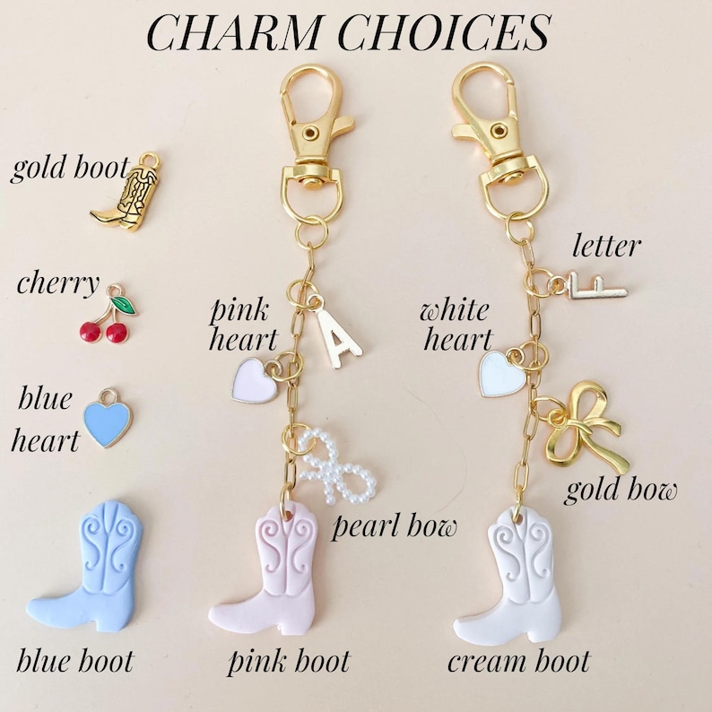 May include: A gold chain with charms, including a pink heart, a white heart, a gold bow, a pearl bow, a letter F, a blue heart, a pink boot, a cream boot, a gold boot, a cherry, and the letter A. The charms are labeled with their names.