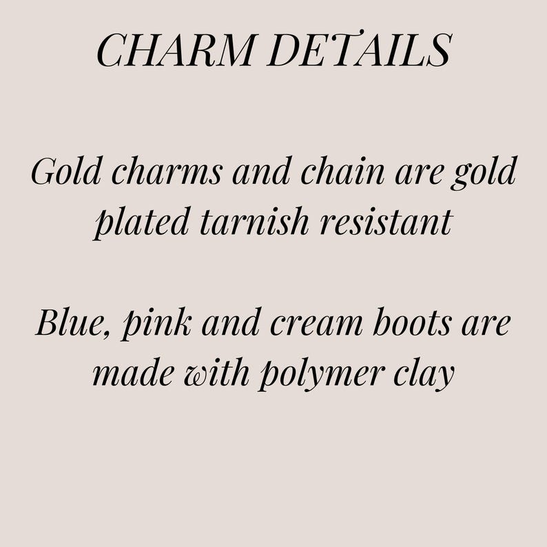 May include: Charm details text explaining that the gold charms and chain are gold plated and tarnish resistant. The blue, pink, and cream boots are made with polymer clay.