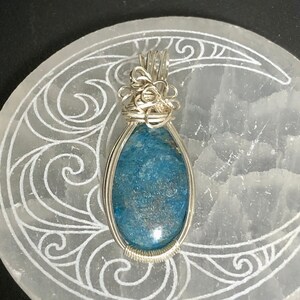 Blue Banded Agate stone pendant wrapped in silver plated wire