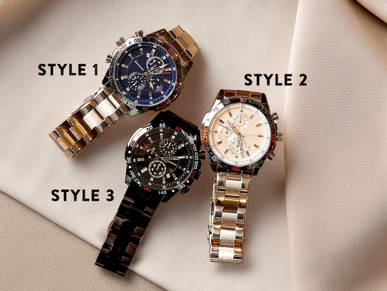 a couple of watches sitting on top of a white cloth