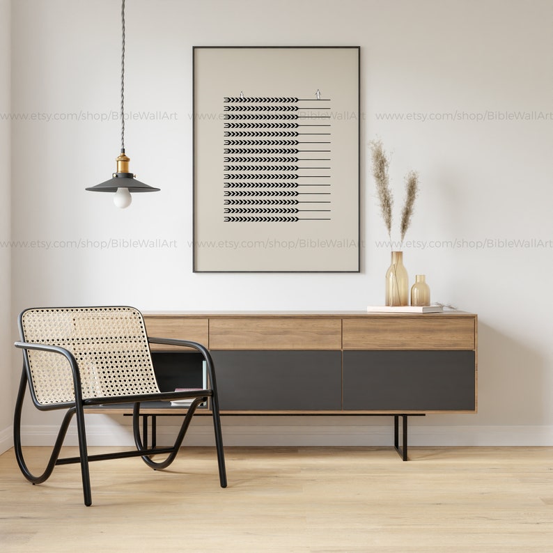May include: A black and white minimalist print of wheat stalks hanging on a white wall above a wooden dresser with a black top and a black and white woven chair.