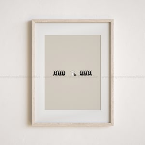 May include: A framed print with a beige background and a black and white illustration of a group of people in a line. The person in the middle is white and the rest are black. The text "www.etsy.com/shop/BibleWallArt" is at the bottom of the image.