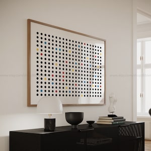 May include: A framed print with a black and white background and a grid of colorful circles in red, yellow, and blue.