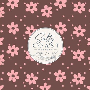 May include: A brown background featuring a repeating pattern of light pink six-petaled flowers and small dots. Centered is a circular logo with the text Salty COAST DESIGNS above a line drawing of a breaking ocean wave and beach grass.