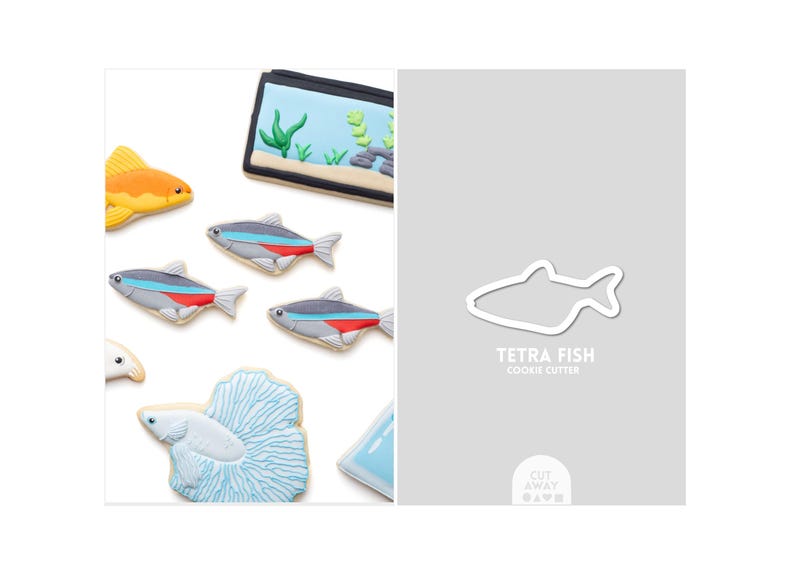 May include: An assortment of decorated fish-shaped cookies, including a goldfish, tetra fish, and a betta fish. The cookies are arranged with a cookie cutter outline and a miniature aquarium cookie. The text "TETRA FISH COOKIE CUTTER" is visible.