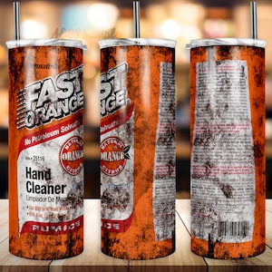 May include: A rusty orange and white tumbler with the words "Fast Orange" and "Hand Cleaner" printed on it. The tumbler has a black lid and a straw.