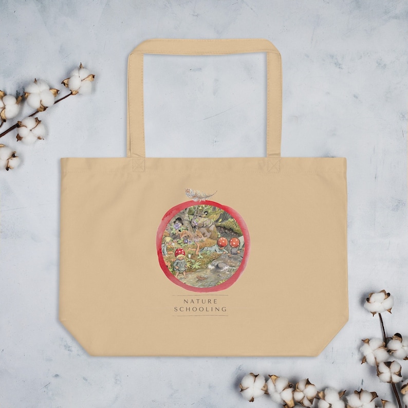 May include: A beige tote bag with a red circle design featuring a nature scene with a small animal and mushrooms. The text "NATURE SCHOOLING" is printed below the circle.