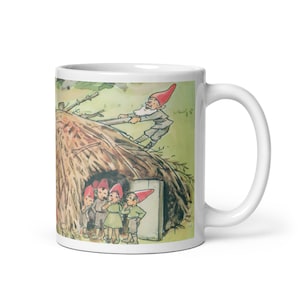 May include: A white ceramic mug featuring a colourful illustration of a group of gnomes. One gnome is pushing a pile of hay with a stick, while the other gnomes are standing inside a small hut made of hay.