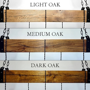 May include: Three reclaimed wood beams with black metal brackets and chains hanging from the ceiling. The beams are shown in three different wood stain colours: light oak, medium oak, and dark oak.