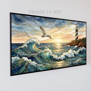 May include: A rectangular digital display showing a stained-glass style artwork of a coastal scene. The image features a large crashing ocean wave, a flying seagull, and a lighthouse on a rocky cliff under a sunset sky with gold outlines.