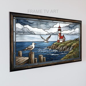 May include: A rectangular wall art piece in a dark wood frame featuring a stained glass style scene of a lighthouse on a rocky cliff, a wooden pier, and two seagulls. The sky is filled with grey clouds, and the text Nature Escape TV Art is visible.