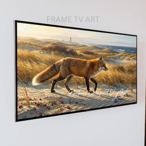 May include: A framed digital art piece featuring a red fox walking on a sandy beach with tall grass and a lighthouse in the background. The artwork is labeled "FRAME TV ART" at the top.