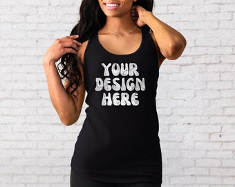 May include: A black tank top with the text "YOUR DESIGN HERE" in white lettering. The text is in a retro, bubble-like font.