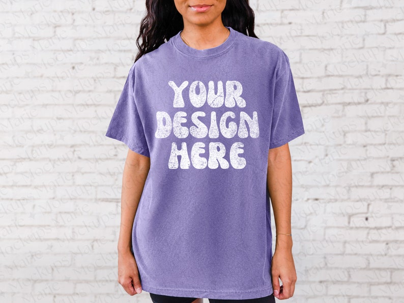 May include: A purple t-shirt with a white vintage-style graphic that says "YOUR DESIGN HERE".