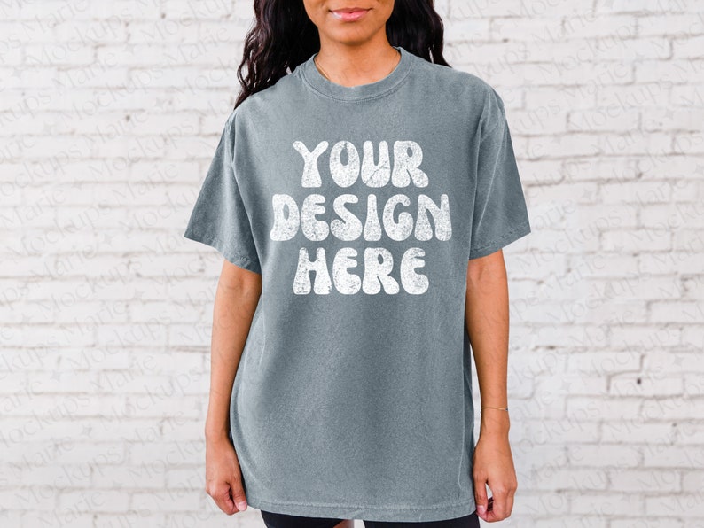 May include: A blue t-shirt with the text "YOUR DESIGN HERE" in white, retro-style lettering.