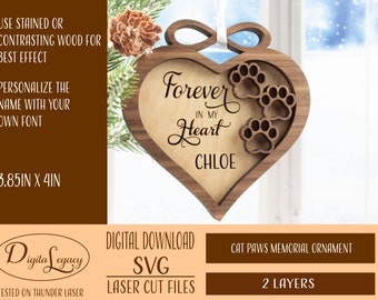 Op de afbeelding: Een houten hartvormige ornament met een lasergesneden ontwerp met poot afdrukken en de tekst "Forever in my Heart Chloe". De ornament is 9,8 cm bij 10,2 cm en is ontworpen voor lasersnijden.