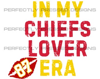 May include: Red and yellow graphic text that reads "In My Chiefs Lover Era" with a red lip print with the number 87 inside.