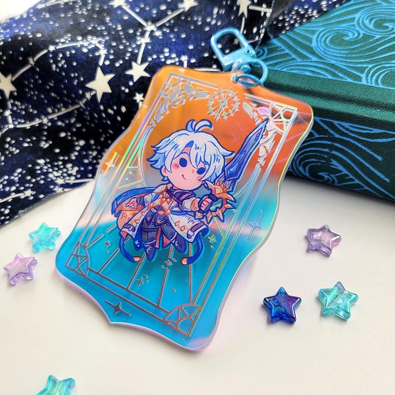 May include: A rectangular, iridescent acrylic charm featuring a cartoon character with blue hair and a sword. The charm has a blue clasp and is set against a gradient background of orange and blue. Several star-shaped beads are scattered around the charm.