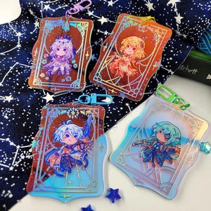 May include: Four holographic acrylic keychains featuring anime-style characters. Each keychain has a unique design with vibrant colors and a decorative border. The keychains are attached to colorful clasps and are displayed on a starry background.