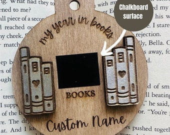 May include: Wooden ornament shaped like a circle with a chalkboard surface. The ornament has a design of books and the text "My year in books".