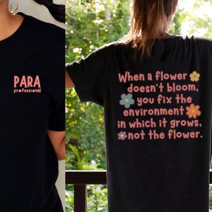 May include: Two black t-shirts with different pink text designs. The first shirt says "PARA professional" and the second shirt says "When a flower doesn't bloom, you fix the environment in which it grows, not the flower." with small flower graphics.