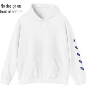 May include: A white hoodie with a kangaroo pocket and drawstring hood. The left sleeve features a series of blue brushstroke designs. The text "No design on front of hoodie" is visible in the image.